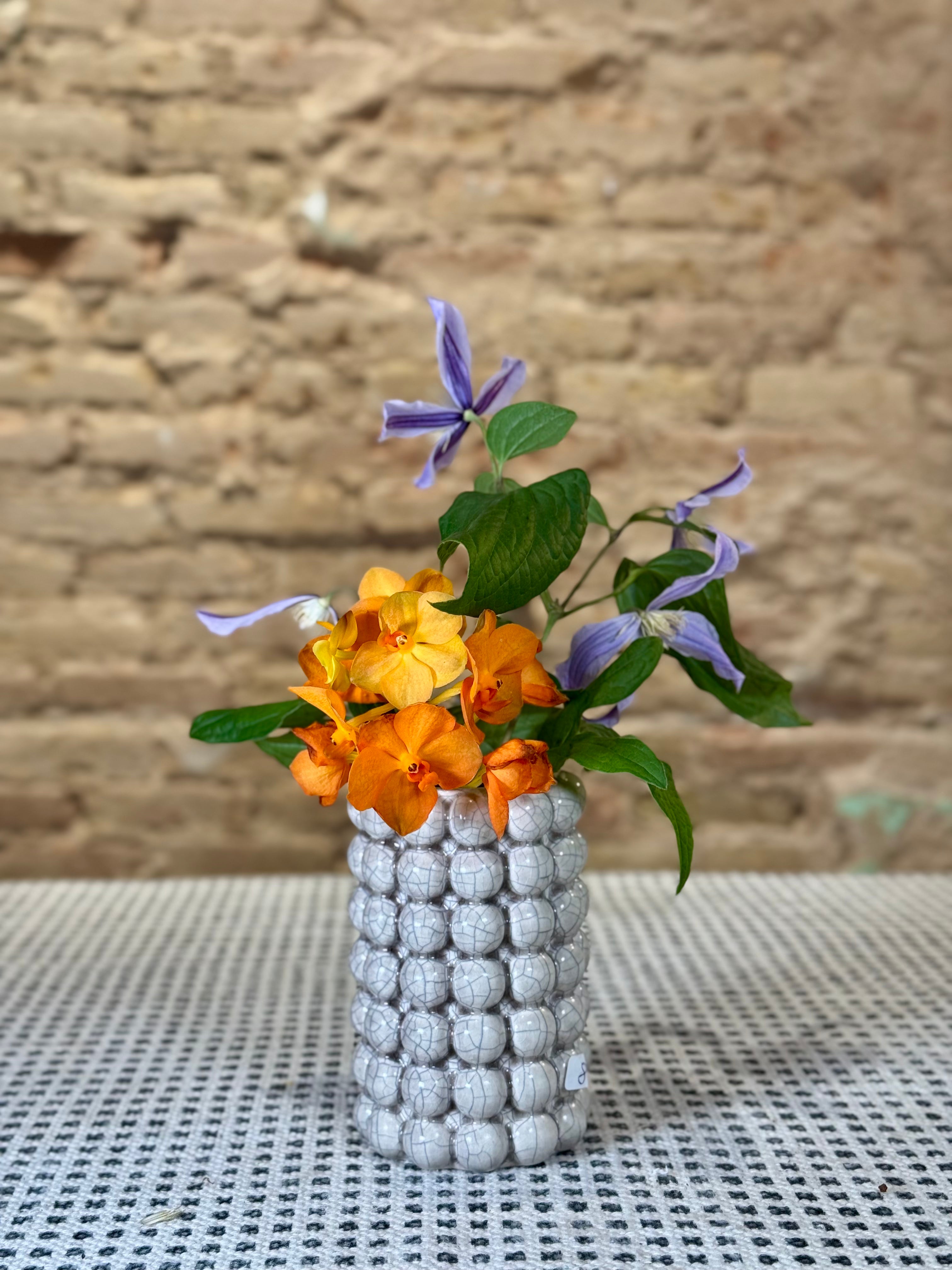 Florero de cerámica gris con motivos de pequeñas bolas